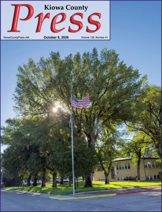 Photo of the week from the October 9, 2026, edition of the Kiowa County Press in Eads, Colorado - Morning sun filters through the trees as the American flag flies over the lawn of the Kiowa County Courthouse in Eads. - Chris Sorensen.